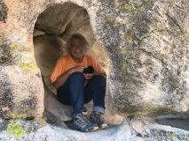 Don about to photograph a pictograph inside an overhang